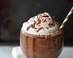Image of person sipping hot chocolate in a snowy New York City