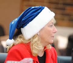 Board chair Denise Ilitch wore a UM Santa&#39;s hat during the performance by Amazin&#39; Blue. The front of the hat was embroidered with “Michigan.” - IlitchSanta