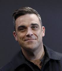 British singer Robbie Williams arrives on the red carpet for the German premiere of &quot;Cars 2&quot; in Munich July 28, 2011. Reuters - 139348-british-singer-robbie-williams-arrives-on-the-red-carpet-for-the-germa