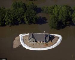 Image of sandbags protecting a house from flood
