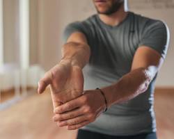 Gambar person doing hand stretches