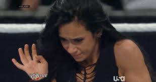 AJ Lee Holding in Anger AJ Lee Holding in Anger WWE wrestler AJ Lee tries to hold in her anger after losing a wrestling match. - AJ-Lee-Holding-in-Anger