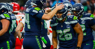 Seattle Seahawks and Kansas City Chiefs players preparing for a Week 7 NFL matchup
