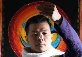 Tsang Man-tung holds a crystal pendulum above a semicircular chart, which reads &quot;things that need attention in the future&quot;. - 20130110141644