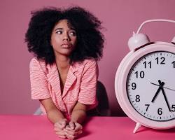 Image of stressedout person looking at a clock