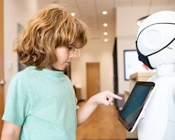 Изображение: child interacting with a social robot that teaches them about emotions, empathy, and communication