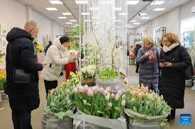 People visit flower show to celebrate upcoming International Women's Day in St. Petersburg, Russia