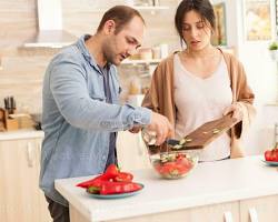 Image of person happily pouring olive oil on a salad