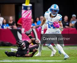 Licensable picture: Detroit Lions receiver Amon-Ra St. Brown (14) returns a punt against the Arizona Cardinals during a game at State Farm Stadium
