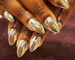 Dark skin with gold nail polish