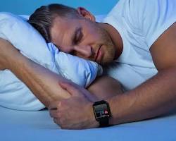 Image of someone sleeping peacefully while wearing a smartwatch