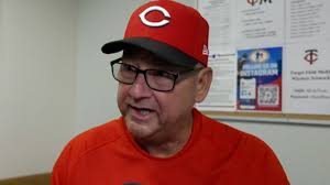 Reds players celebrating a crucial win against the Twins