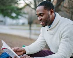 Image of person reading a book about personal finance