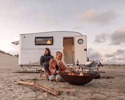 Image of happy couple towing a trailer