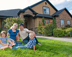Image of happy family in front of a house