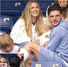 Rice, Rice... baby! Three Lions star in stands with mystery tot