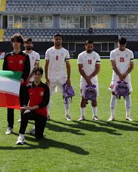 Iranian soccer players hold schoolbags in solidarity with slain girls
