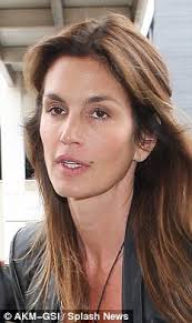 Looking sensational: Even with a make-up free face Cindy Crawford looks half her. Ready for bed: But even when tired, Cindy still looks great - article-0-14F7A056000005DC-531_233x390