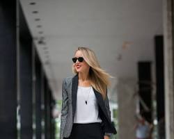Image of Woman in blazer, trousers, and flats