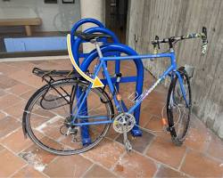 Image of bike properly locked to a bike rack with a Ulock through the frame and rear wheel, and a cable lock securing the front wheel