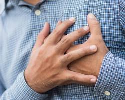 Image of Person having a heart attack clutching their chest