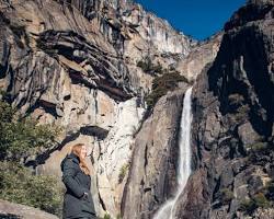 Image of hiker on the trail to Yosemite Falls, with the falls in the background