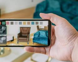 Image of person shopping online using an AR app to visualize a product in their home