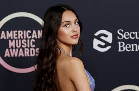 Olivia Rodrigo surprises little fan by showing up at her talent show, after Pilates chance meeting with the girl’s mom