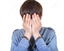 Image of person in handcuffs with a sad face