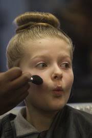 Evie Parker, 9, puckers for her makeup application Wednesday at the Lawrence campus of Marinello Schools of Beauty at the Day of Beauty for young ladies ... - day_of_beauty_rg014_t180