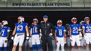 UH football Houston Cougars players running onto the field at TDECU Stadium during the 2026 season