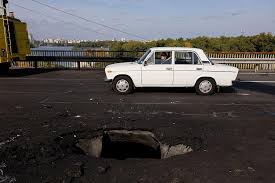 Kyiv bridge hit in further Russian drone attack as German chancellor makes surprise visit - BBC