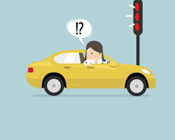 Image of confused driver at a traffic light