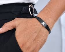 A rugged shot featuring Voylla's men's collection, specifically a thick link bracelet and a traditional kada.