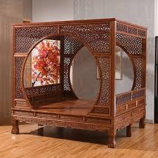 Boxy, elaborately carved wooden bedframe