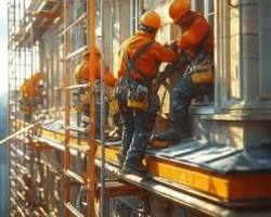 Image of building with scaffolding and workers repairing it