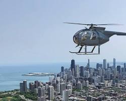 Image of helicopters flying over Chicago skyline