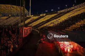 Greek soccer club PAOK supporters light candles in memory of their fellow supporters who died in a road accident in Romania