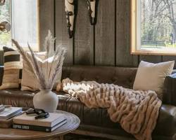 Image of Light and airy wallpaper with tan brown sofas