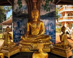 Image of Thai couple making merit at a Buddhist temple in Thailand