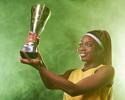 young woman holding a trophy smiling celebrate victory، من إنشاء الذكاء الاصطناعي