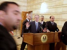 President George W. Bush reacts after a man threw two shoes at him during a news conference with Iraqi Prime Minister Nouri al-Maliki. - 081214_bush_allen