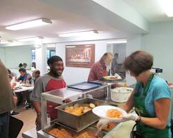 Image of person volunteering at a soup kitchen