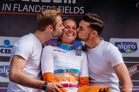 female cyclist being kissed by podium boys