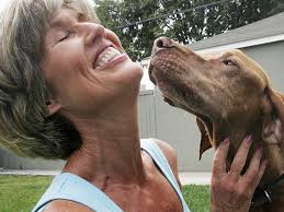 Renee Carleton is an active dog rescuer, here playing with one of her three dogs, Dino, in her backyard. She operates a pet food bank out of her Westminster ... - kpmcbt-25petfood1lrg