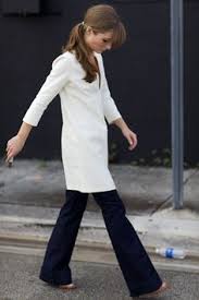 Image result for Images of the slim tunic worn with flared trousers on runway