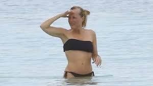 Gillian Anderson, 56, looks sensational as she showcases toned midriff in a 
black bikini during Mexico getaway