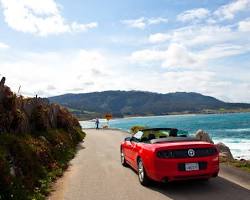 Image of Uber car driving along the California coast