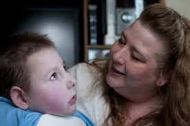 Brenden Neville | The Saginaw NewsMary Hickmott sits with her son Jonathan in their home on Friday, April 29, in Chesaning. Jonathan suffers from a rare ... - 9550077-large