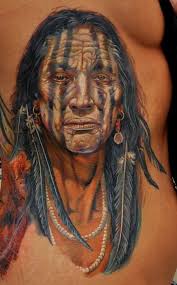 This portrait tattoo of a native American tribal elder uses white tattoo ink to add highlights to the eyes and facial features, creating contrast between ... - This-portrait-tattoo-of-a-native-American-tribal-elder-uses-white-tattoo-ink-to-add-highlights-to-the-eyes-and-facial-features